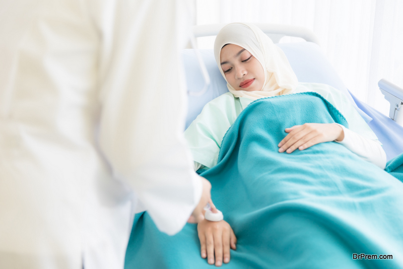 Muslim female patient wearing hijab dress lay down on bed in hospital