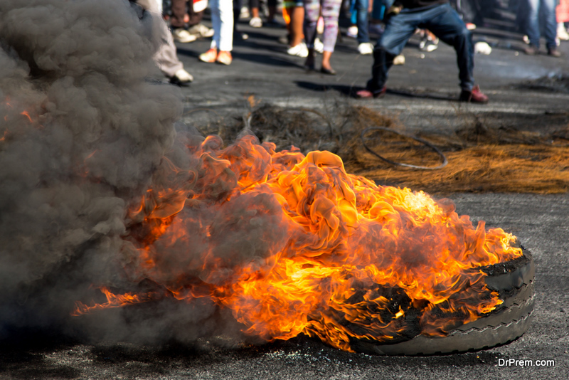 Protesters against the government burning rubber tyres in the streets