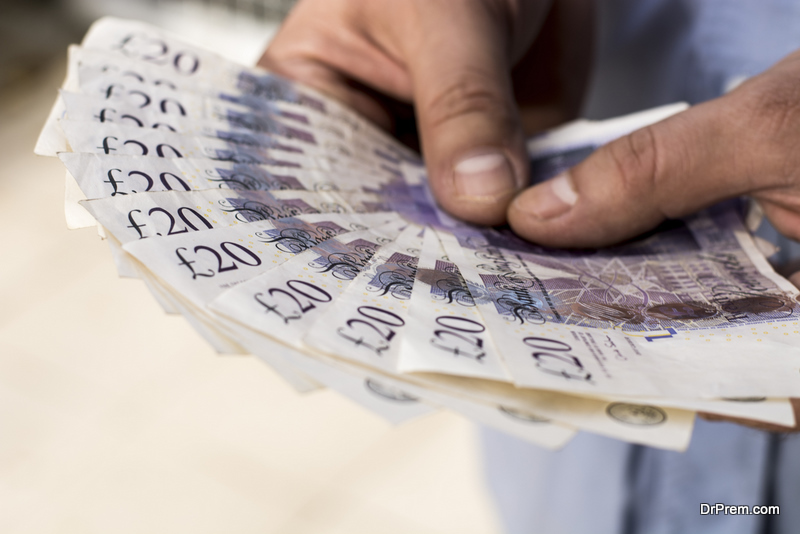 Twenty pound banknotes in man's hands