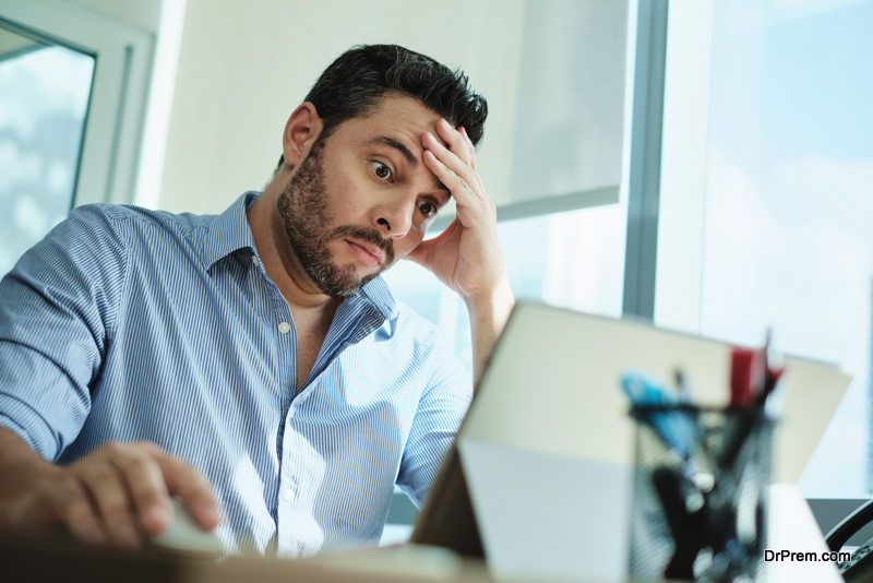 Upset man working with laptop 