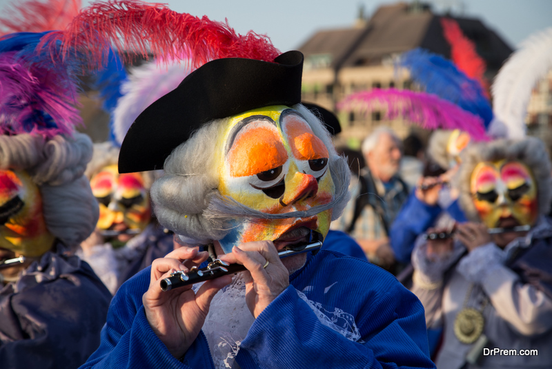 Waggis playing the piccolo at the Basel carnival in Switzerland