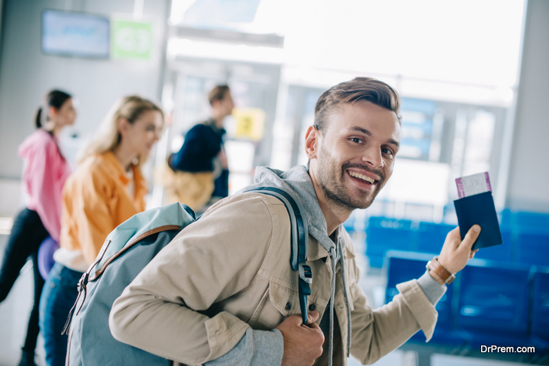 Young man smiling at camera in airport