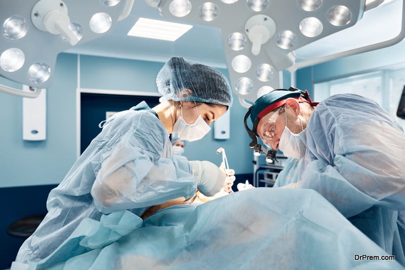 a team of male and female doctors perform surgery