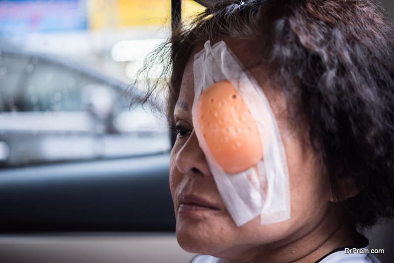 elder woman with eye shield after cornea surgery (lasik)