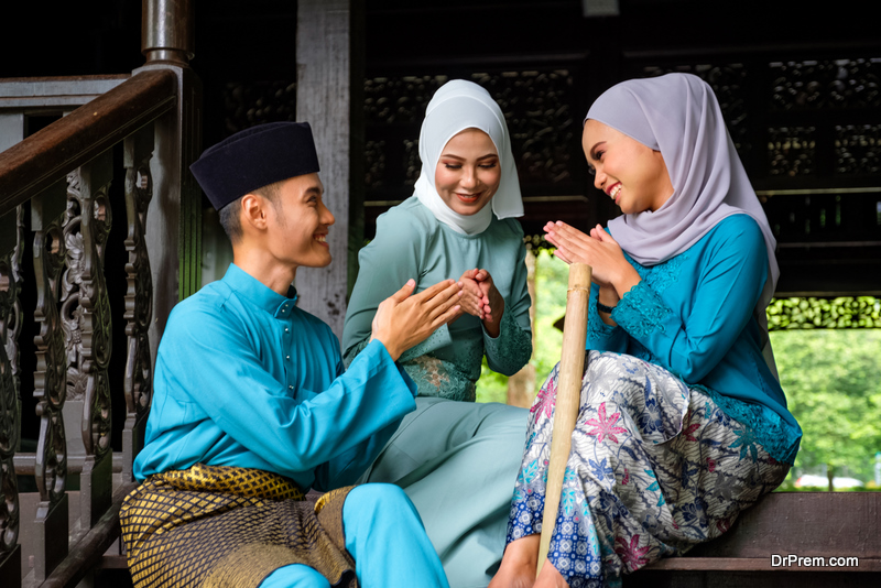 group of three malay people in traditional costume 