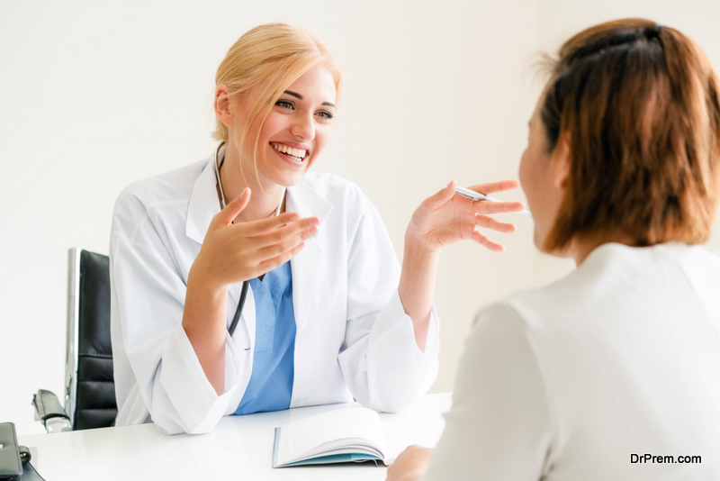 Woman doctor is talking and examining female patient 