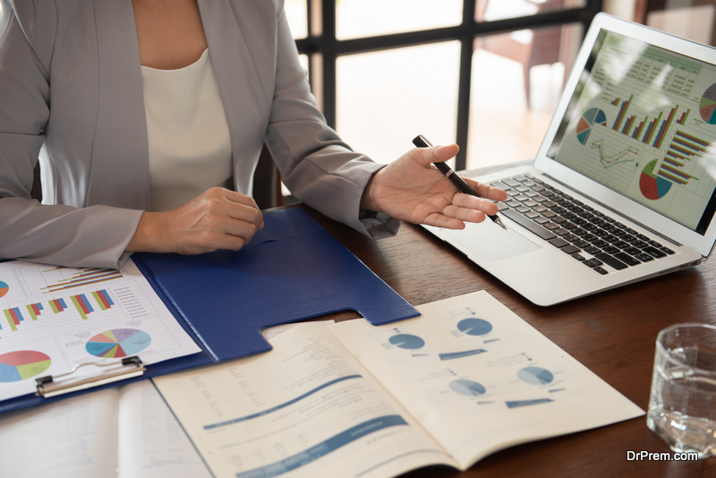  woman reviewing data in financial statement with coworker analyzing market data research