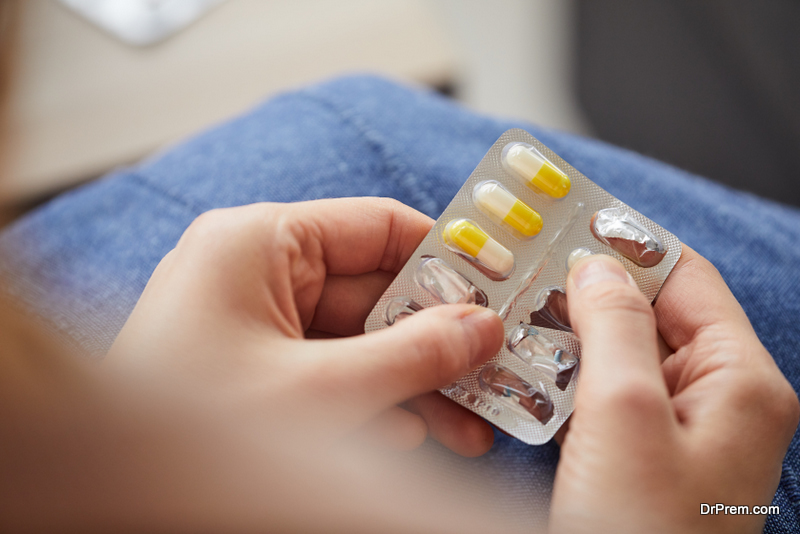  young woman holding pills she is going to take medicine from disease