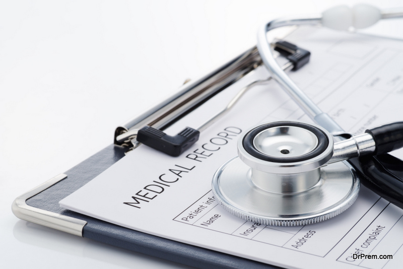 Medical record and stethoscope on white background