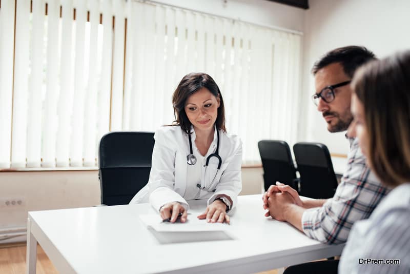 Doctor discussing with couple in the clinic.