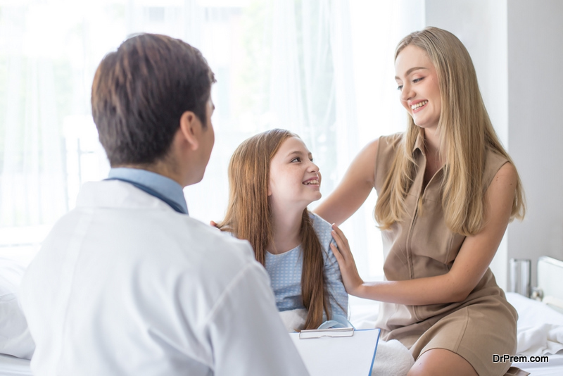 Doctor visit to little patient at hospital with happy emotion together