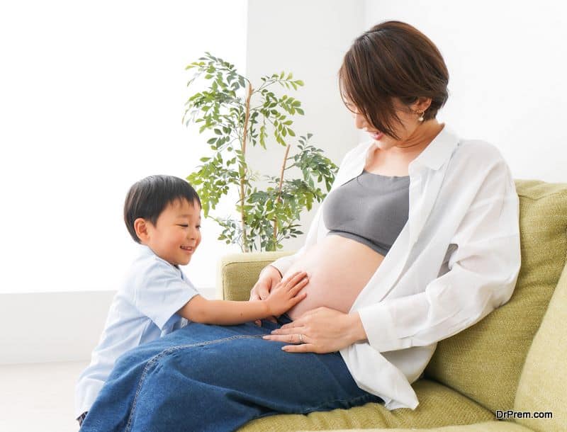 Little boy hear the beating of baby