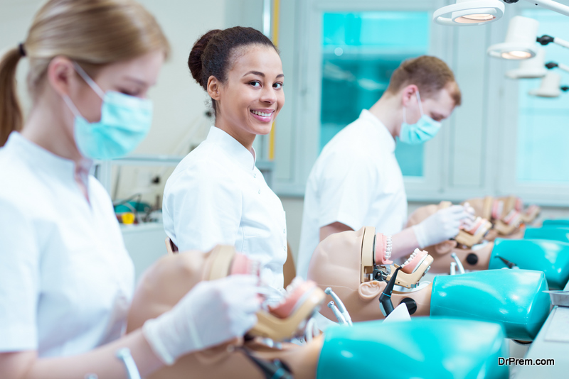 students practice dentistry on plastic jaws