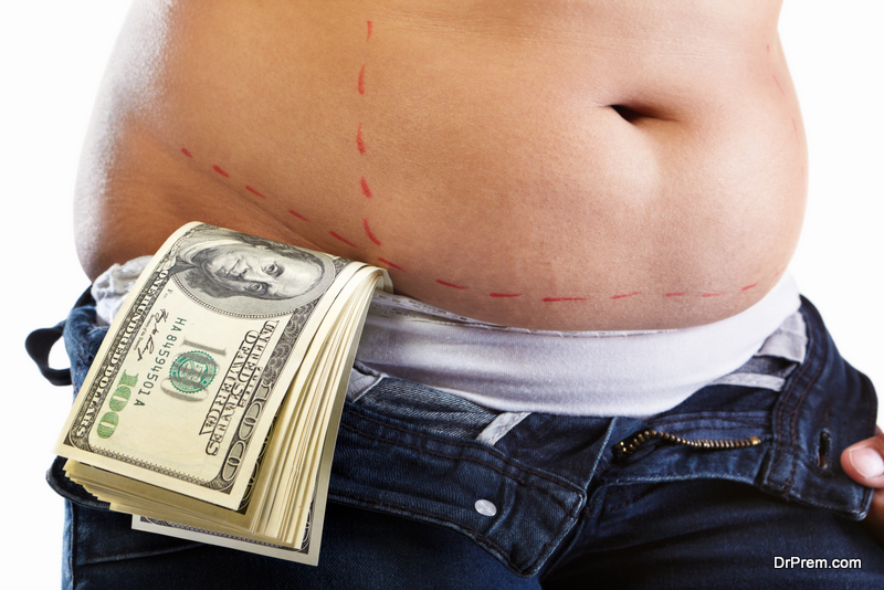 Overweight female stomach being marked by red marker and losts of 100 dollar bills