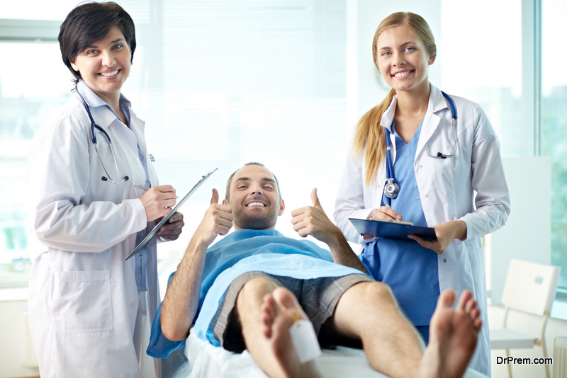 Portrait of a man lying on gurney and two doctors