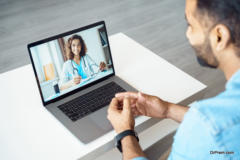 View over client shoulder sit at desk receive medical consultation online