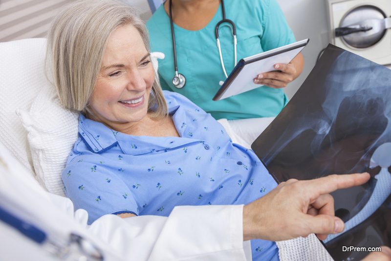 Happy senior woman patient recovering in hospital bed 