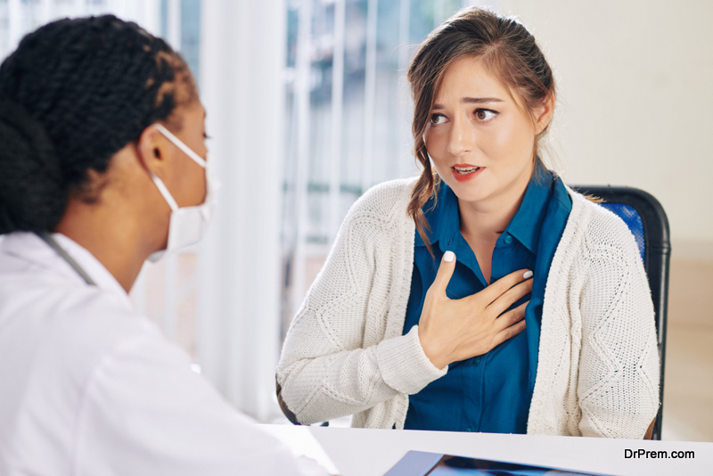 Pretty young woman complaining about chest pain 