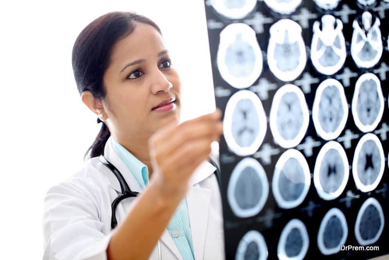 Indian Female doctor examining a brain computerized scan