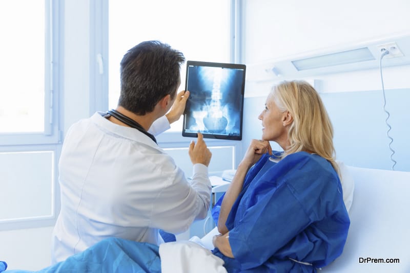 Doctor showing xray to a patient in hospital