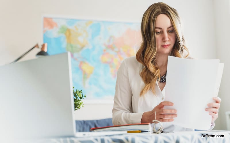 Travel agent working with documents at office.