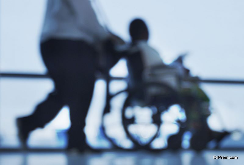  people walking with wheelchair mobility assistance at airport 