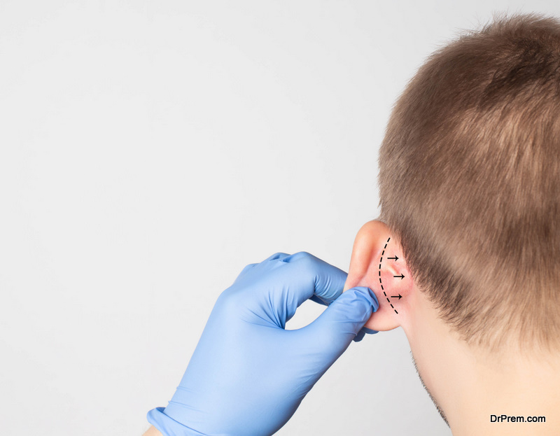 A-plastic-surgeon-doctor-examines-a-male-patient-s-ear-for-an-otoplasty-operation