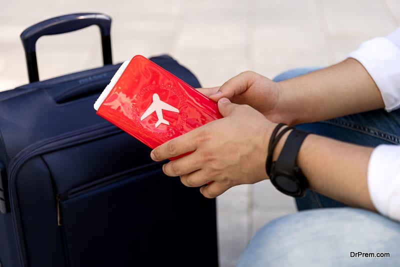 Man sitting on a bench with a suitcase