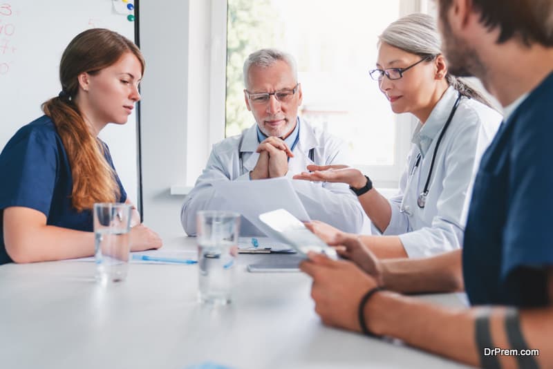 Team of healthcare workers discussing in boardroom 