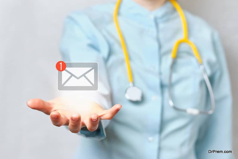 Doctor holds an abstract email with a hand in his hand.