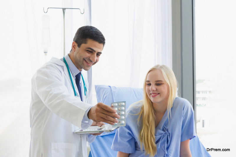 Focus on the medicine panel held by a male doctor introducing a female patient to sit on bed at hospital