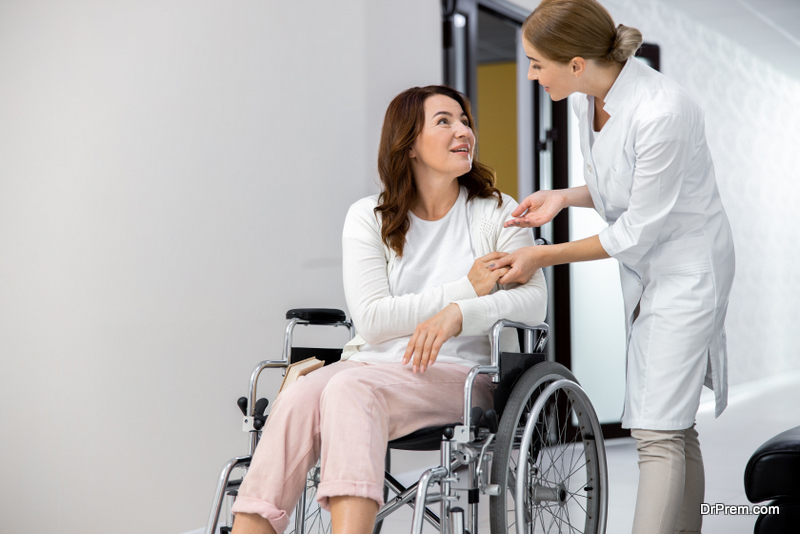 Friendly doctor talking with disabled patient