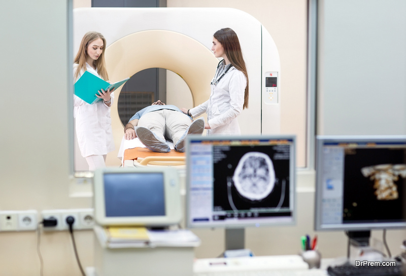 MRI machine and screens with doctor and nurse