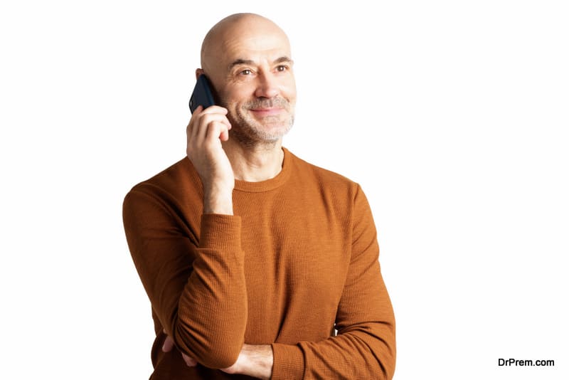 Smiling mature man talking with somebody on his mobile