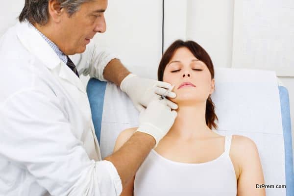 Young caucasian woman receiving an injection of botox from a doctor