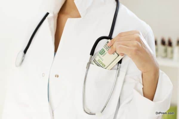 Close-up of female doctor hand placing money in the lab coat pocket.