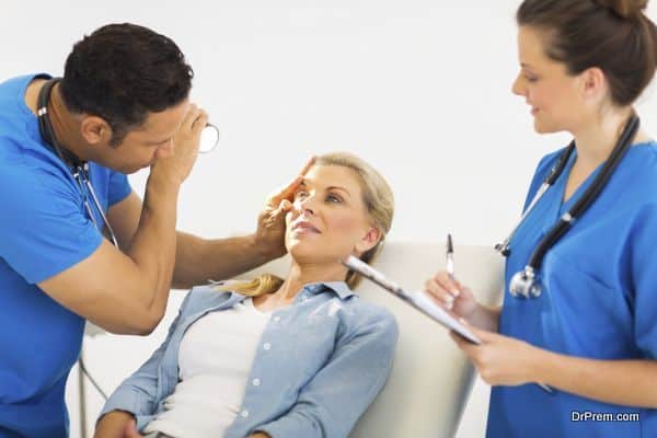 friendly ophthalmologist examining woman's eye