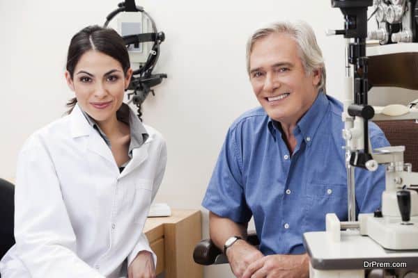 Confident female optometrist smiling with patient in her clinic