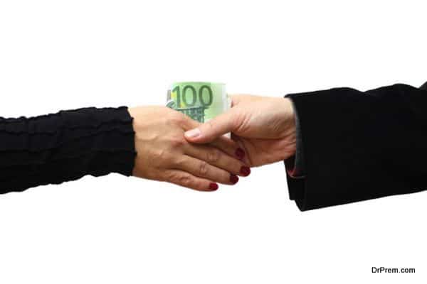 Handshake with money isolated on white background