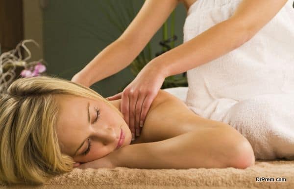 A young woman relaxing at a health spa while having a massage