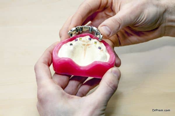 Making Artificial Facial Dental, Isolated on Light Brown Table.