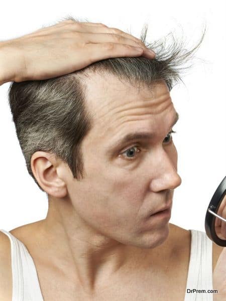 Man with mirror looking at his hair