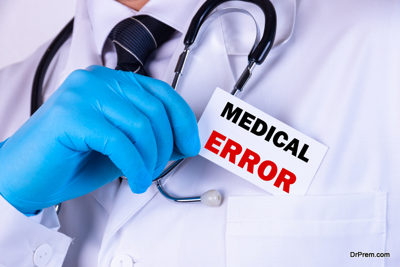Doctor holding a card with text Medical Error medical concept