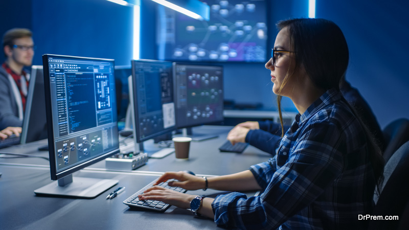  Female IT Programer Working on Desktop Green Mock-up Screen Computer in Data Center System