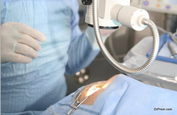 surgeons holding medical instruments in hands and looking at patient