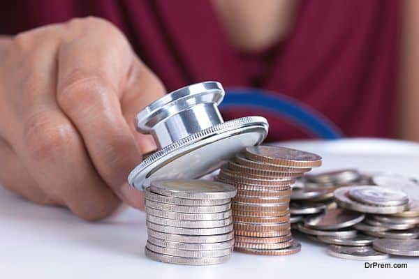 Financial concept, hand hold stethoscope and coins
