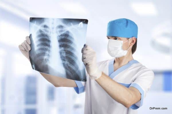 medical doctor looking at x-ray picture of lungs in hospital