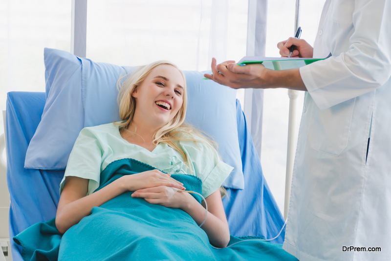 A male doctor visiting a girl patient in the hospital room