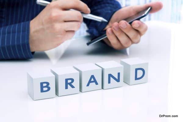 Businessman arranging small blocks with word "Brand"