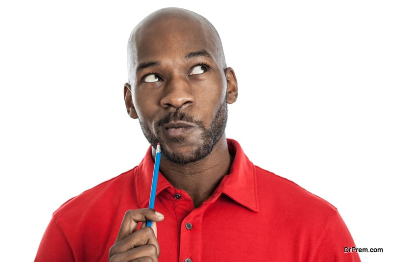 Handsome black man with pencil on chin thinking 